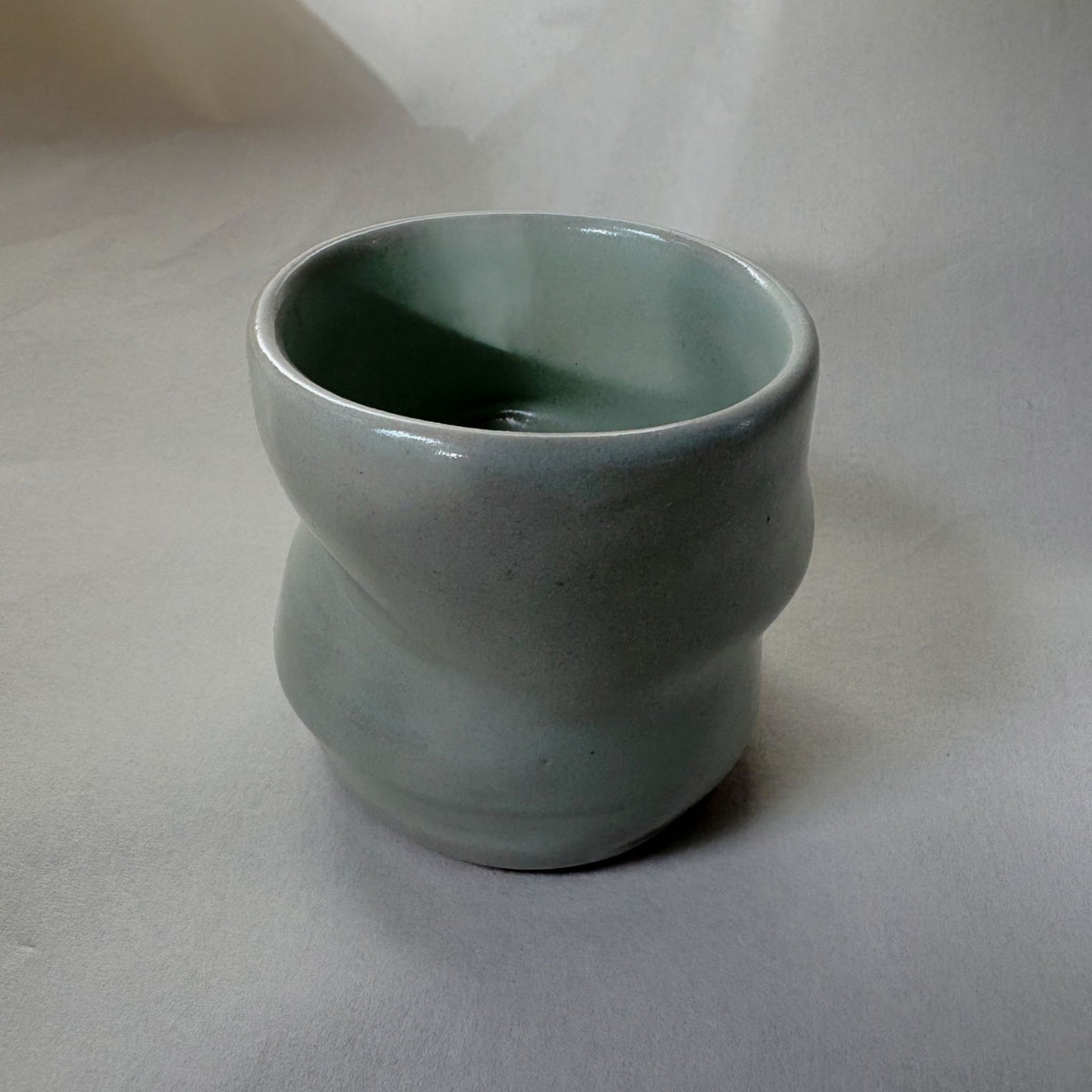 Twisted satin green ceramic coffee cup